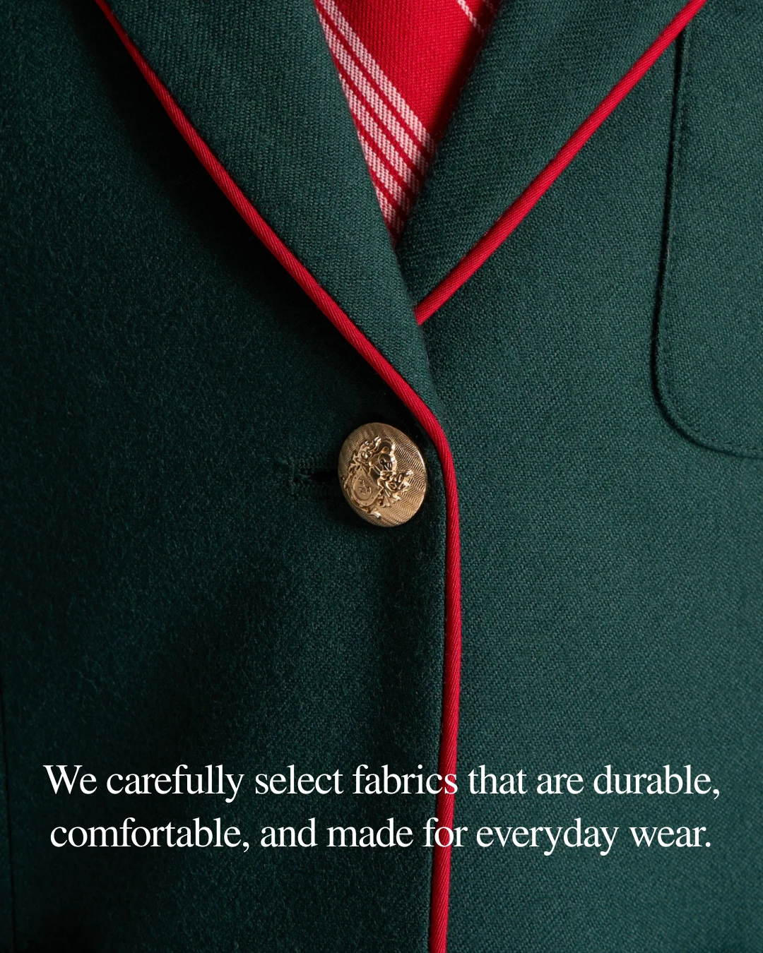 Green blazer with contrasting red piping and a brass button